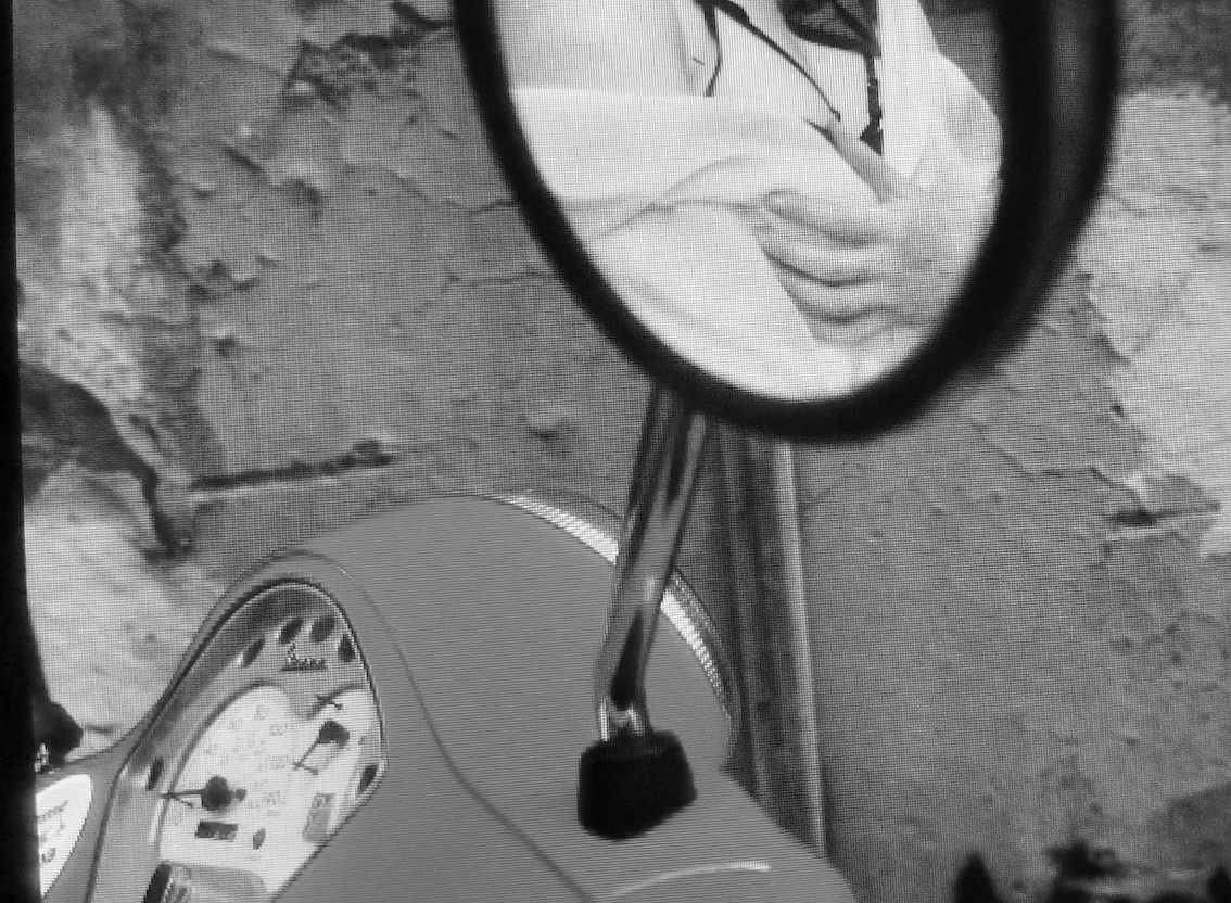 Vespa mirror showing Keira in lingerie